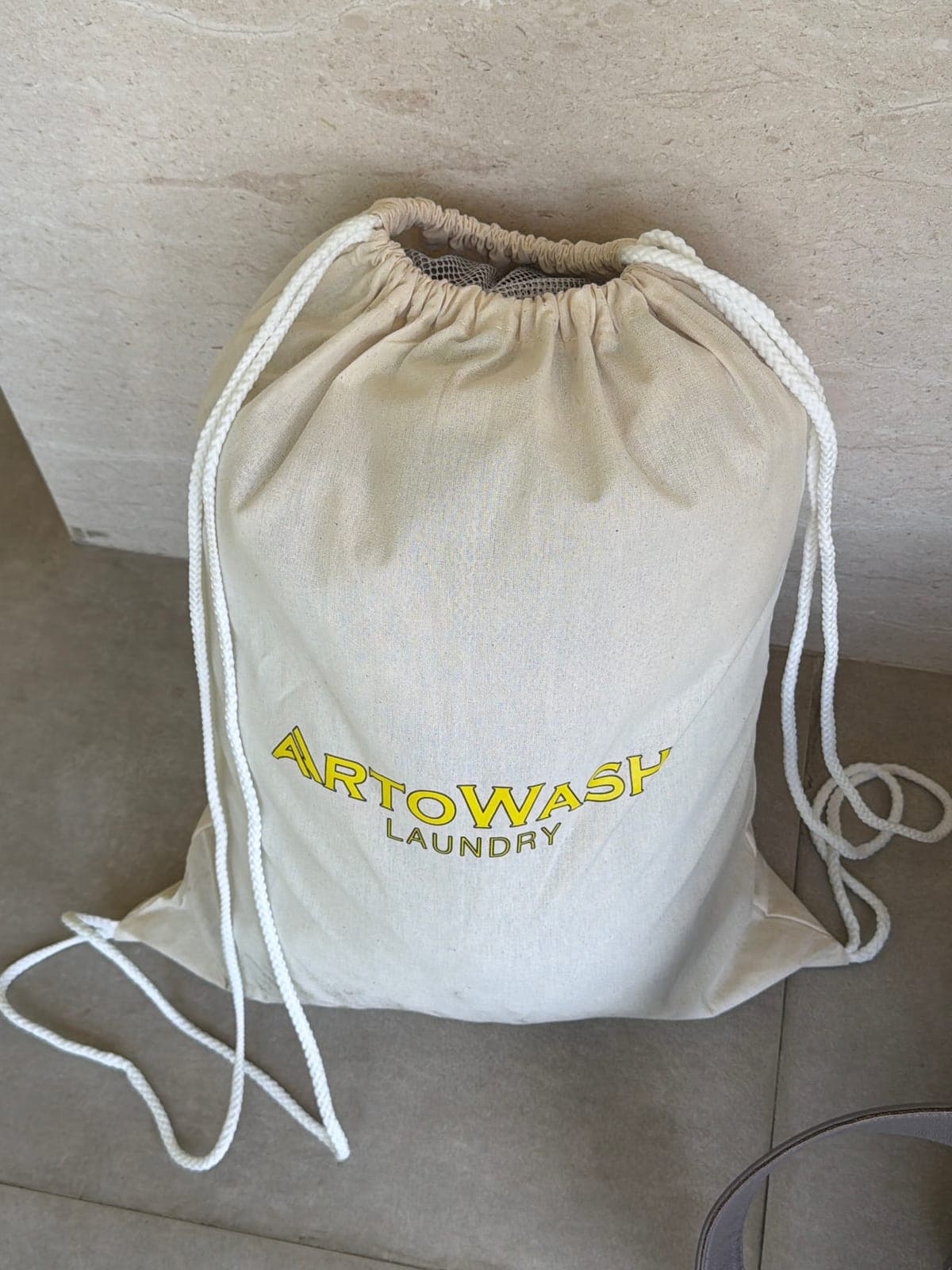 An ArtoWash Laundry drawstring bag