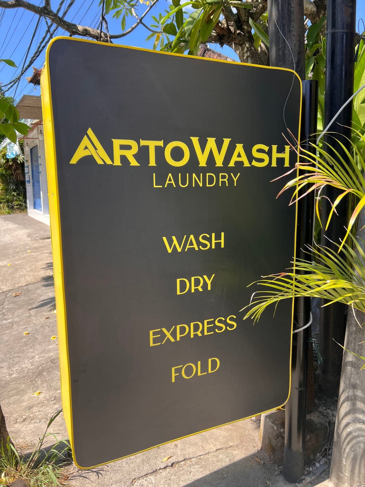 The ArtoWash street sign listing wash, dry, express and fold